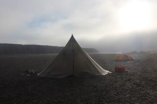 Tents pitched on a sandbar along the Colville River in Alaska, above the Arctic Circle.
