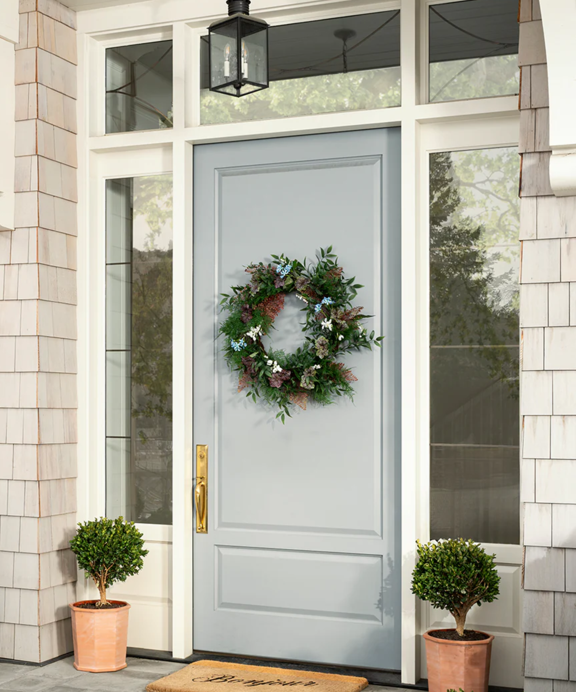 a blue front door with a wreath on it