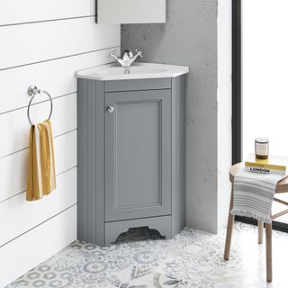 bathroom with ring towel hanger and wash basin with grey cabinet