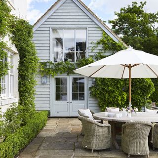 garden with patio umbrella set and stone flooring