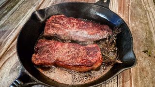 Ooni Karu 16 outside with cast iron strip steaks