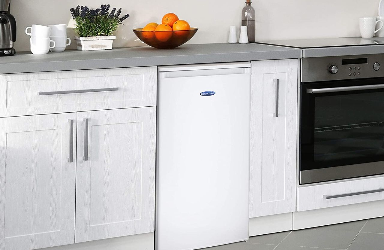 the IceKing RL111AP2 Under Counter Fridge, one of Real Homes&#039; best under counter fridge options, in a minimal white and grey kitchen