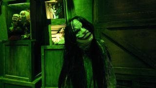 creature with long hair and a wide smile posing at Horror Unleashed in Vegas