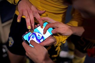 Players of Sweden look at a mobile phone in the dressing room the which displays the Video Assistant Referee (VAR) goal line technology decision for the seventh penalty kick scored by Lina Hurtig of Sweden in the penalty shoot out after the FIFA Women's World Cup Australia & New Zealand 2023 Round of 16 match between Sweden and USA at Melbourne Rectangular Stadium on August 06, 2023 in Melbourne / Naarm, Australia.