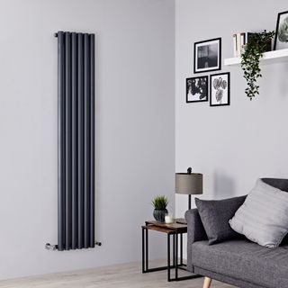 Vertical navy radiator on neutral grey walls in living room
