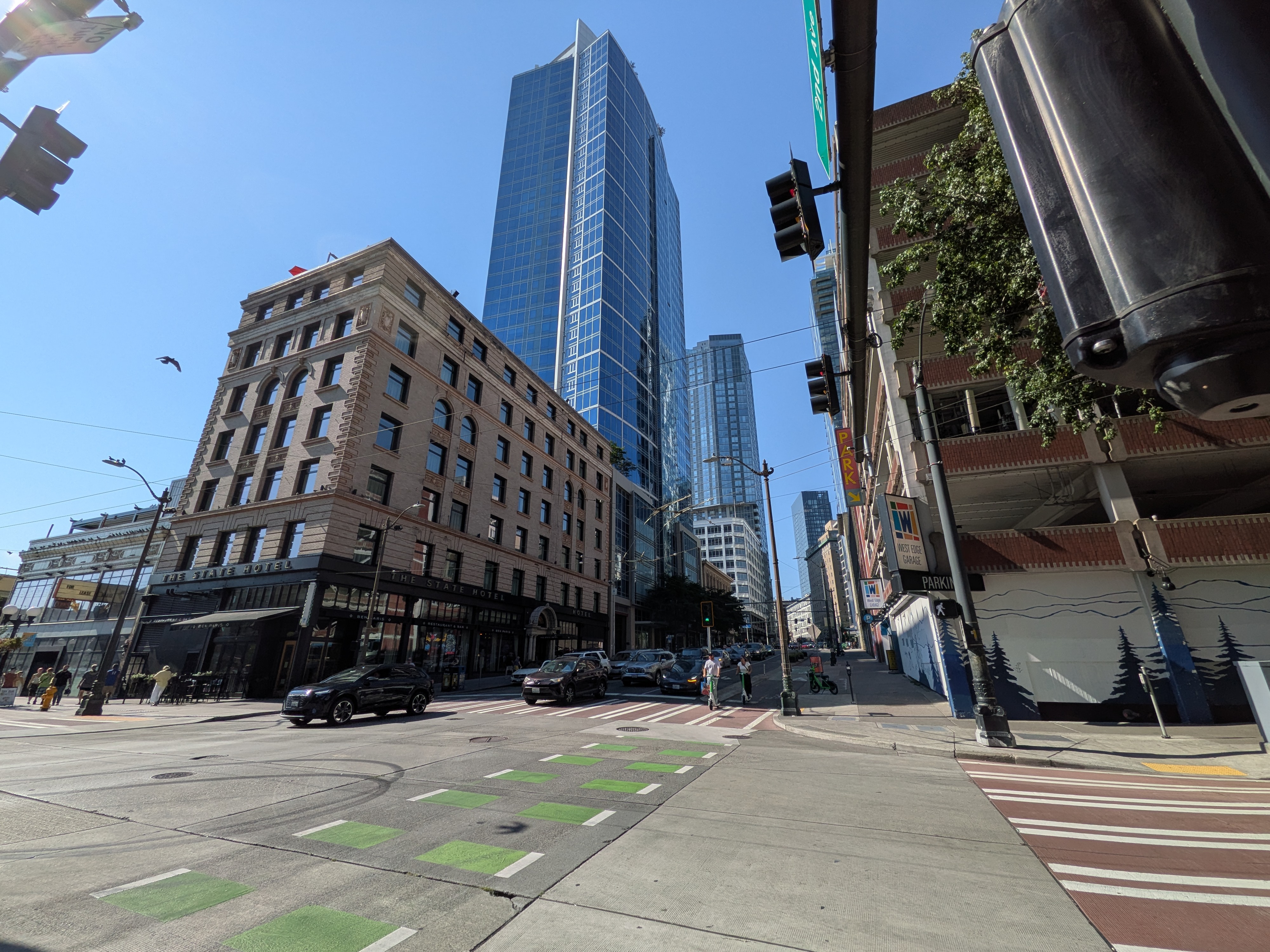 A street with cars between some buildings
