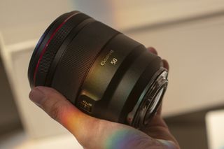 Canon RF 50mm f/1.2 USM in the palm of someone's hand