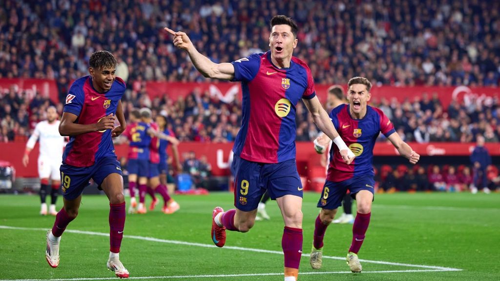 Robert Lewandowski of FC Barcelona celebrates scoring his team&#039;s first goal with teammates Lamine Yamal and Gavi during the LaLiga match between Sevilla FC and FC Barcelona at Estadio Ramon Sanchez Pizjuan on February 09, 2025 in Seville, Spain.