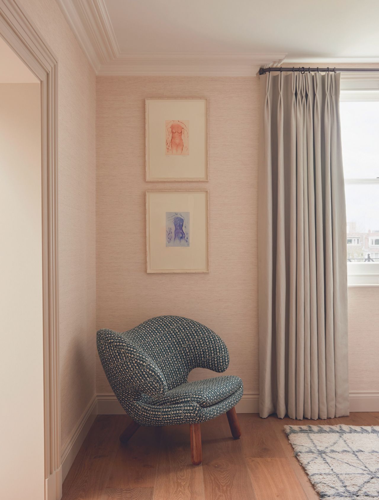 A Pelican Chair in the corner of this bedroom with canvas-textured walls