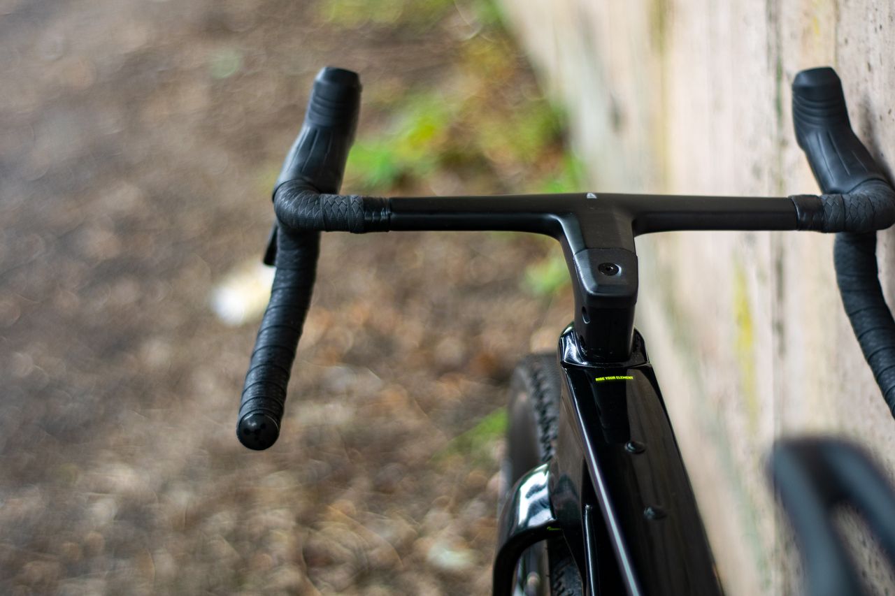 An Argon 18 Anti Matter gravel bike leaning against a concrete wall.