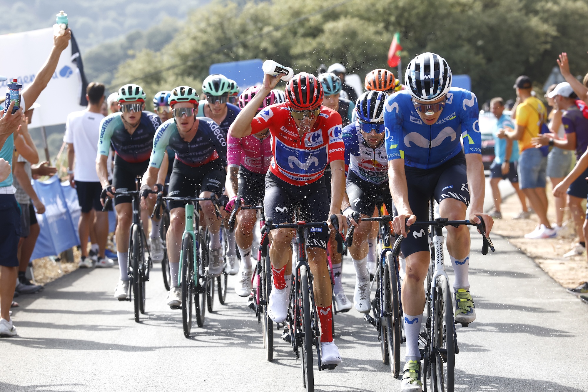 Enric Mas of Movistar Team, in Red Leader Jersey, refreshes with water during climb to the Sierra de la Pandera on Saturday