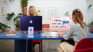 Apple iMac 2021 being used in office by two women