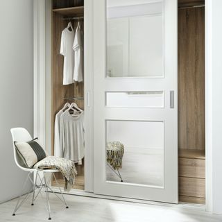 sliding door wardrobes with oak interiors and chair