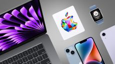 A MacBook, iPhone, Apple Watch and Apple gift box on a grey background