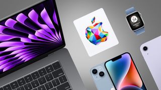 A MacBook, iPhone, Apple Watch and Apple gift box on a grey background
