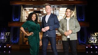 Nyesha Arrington in a green jumpsuit, Gordon Ramsay in a blue jacket and jeans and Paul Ainsworth in a grey top and dark trousers stand in front of the towerng kitchen in Next Level Chef UK.