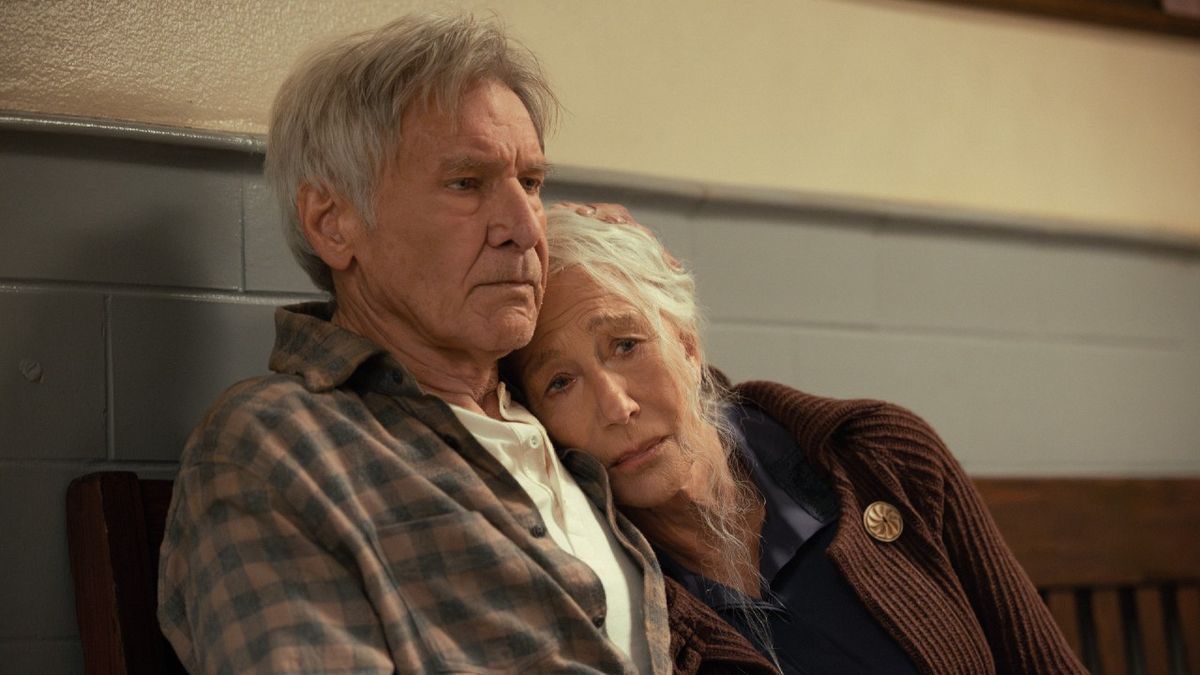 From left to right: Harrison Ford sitting on a bench while Helen Mirren leans on his shoulder and looks very sad in 1923.