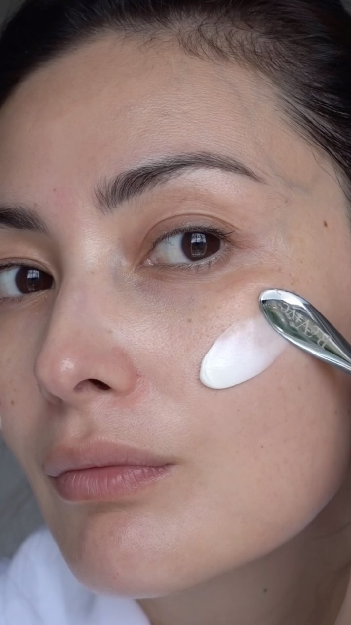 @peonylim applying an eye cream with a silver spatula to her skin