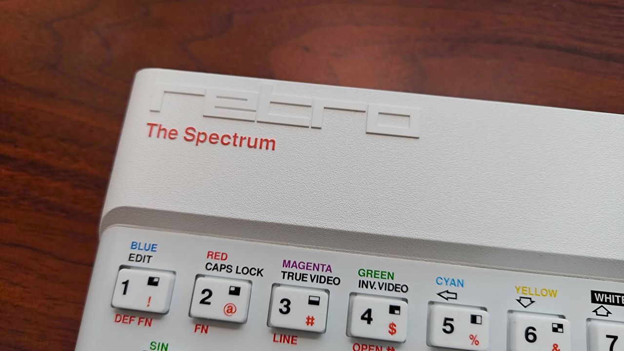 Close up of The Spectrum White Edition top logo bezel.