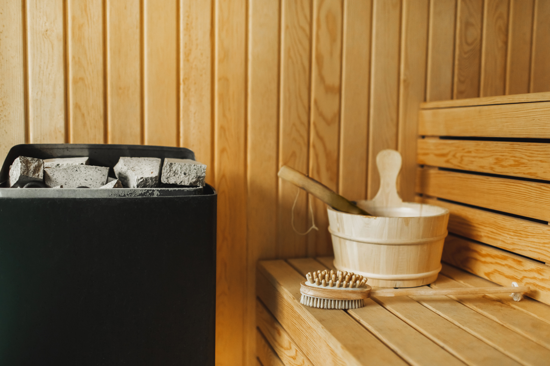 The inside of a sauna with a brush and coal.