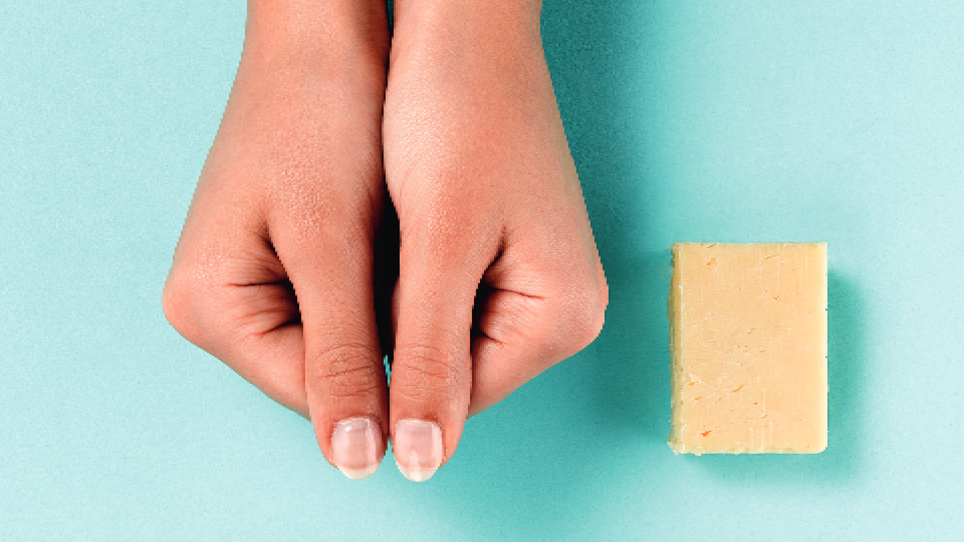 two thumbs next to butter