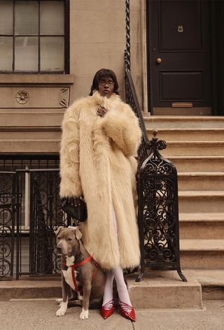 winter tight outfit shown in a photo of a woman wearing a white fur coat over white tights with red pumps