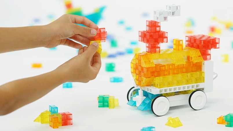child plays with KOOV train