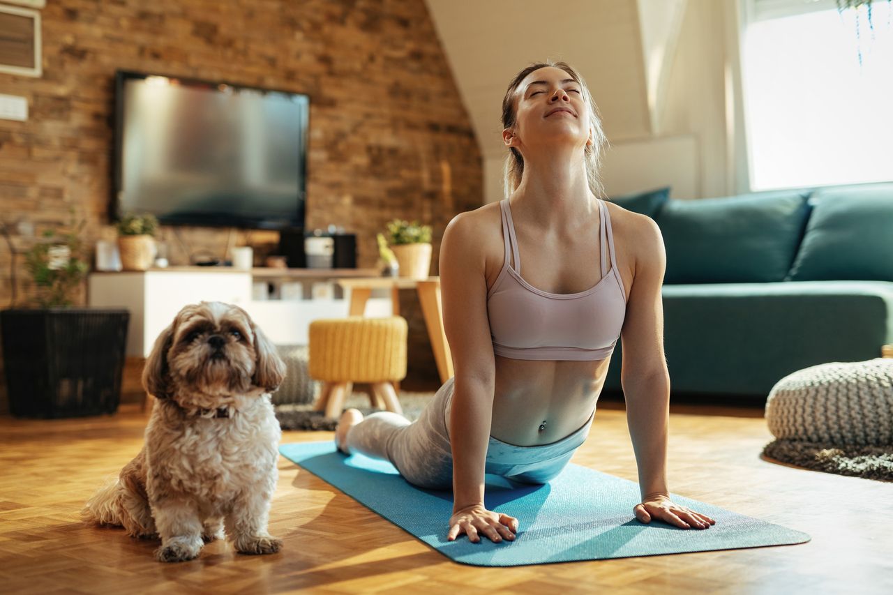 Yoga for beginners: relaxed woman doing an upwards dog