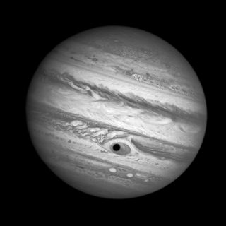Jupiter's eye looks like it has a pupil thanks to the moon Ganymede casting a shadow on the planet.