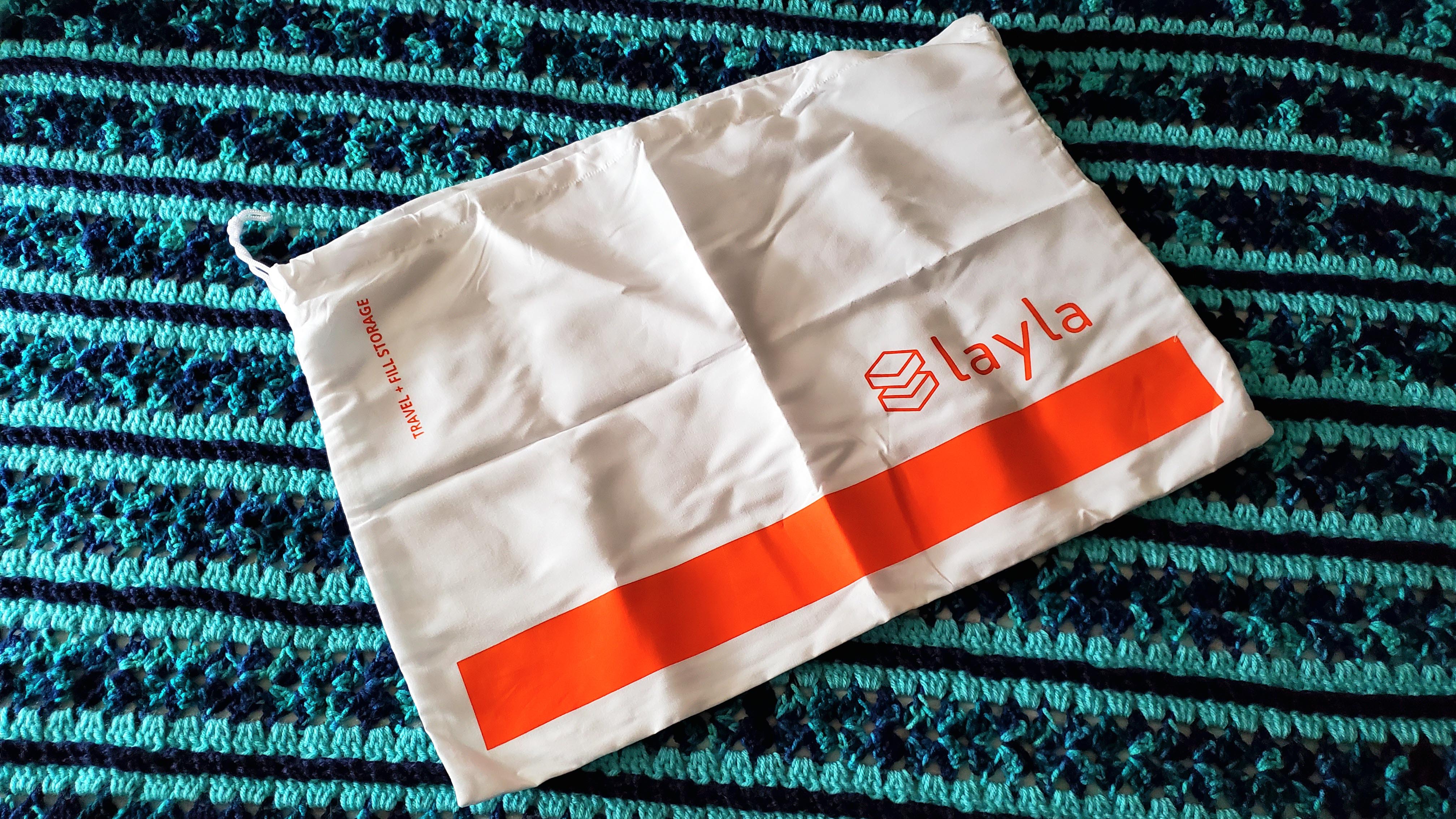 The white and orange dust bag supplied with the Layla Kapok Pillow