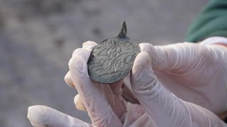 a close-up of a metal amulet