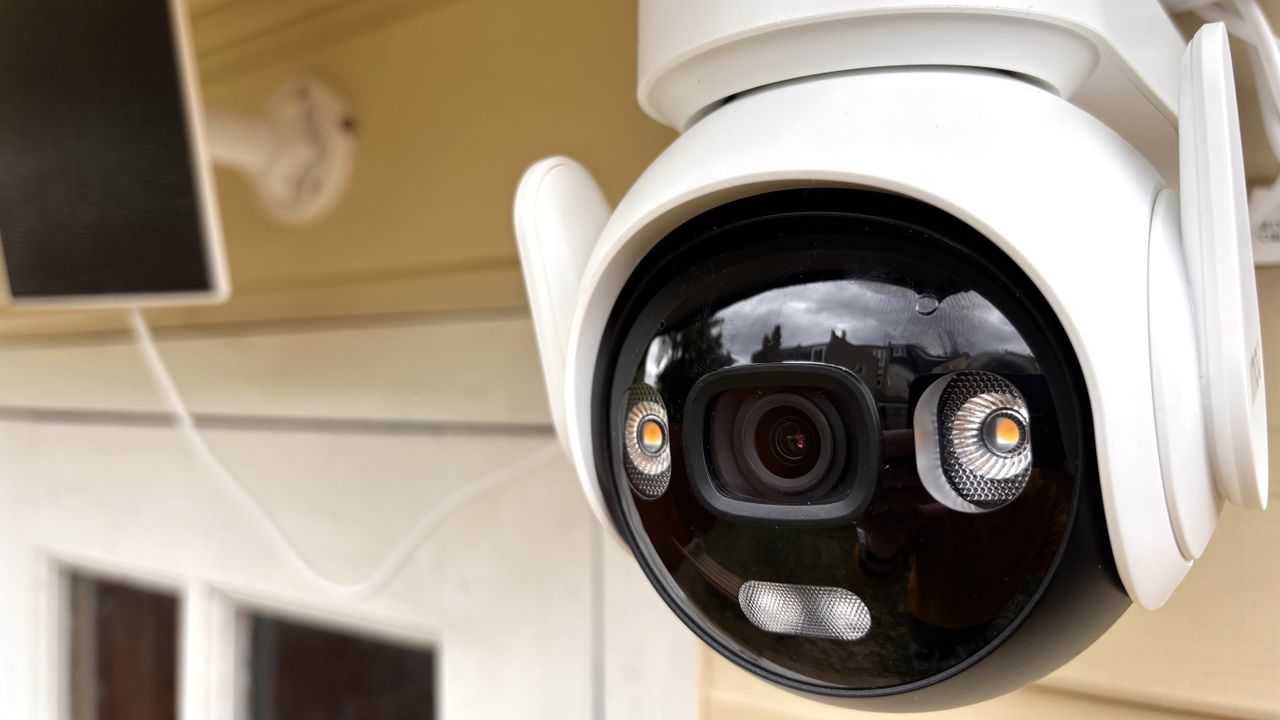 Close-up of IMOU AOV PT security camera mounted outside summer house