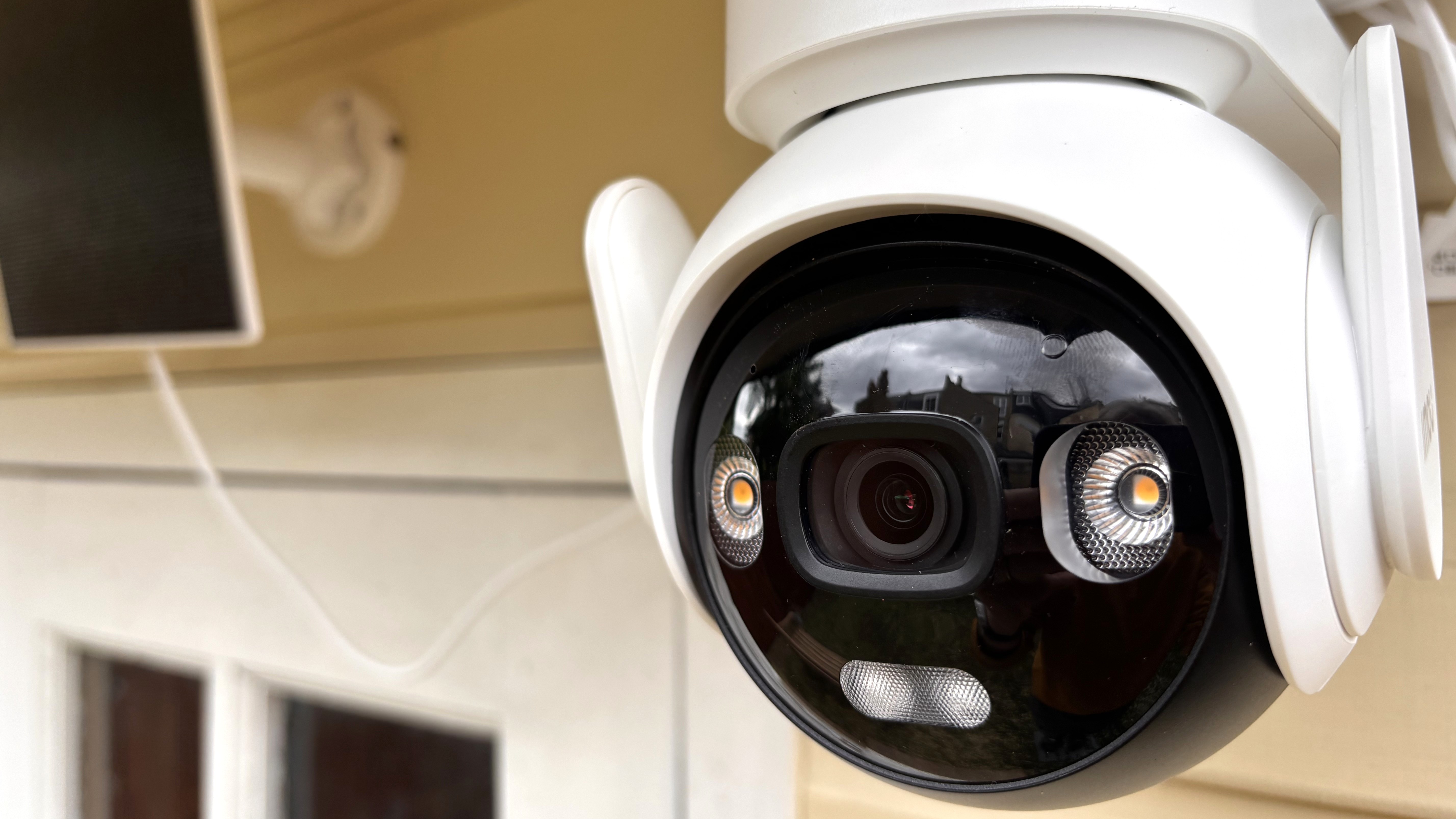 Close-up of IMOU AOV PT security camera mounted outside summer house