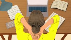 Woman at desk with laptop and book