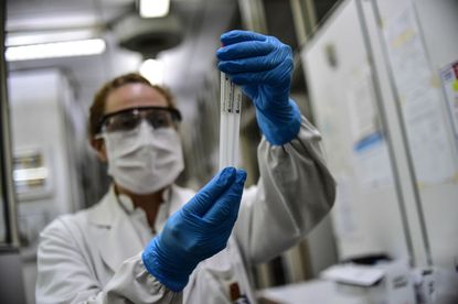 Biochemist Daniela Beatriz Ori manipulates swab samples to make a real time polymerase chain reaction (RT-PCR) analysis for COVID-19 testing at the biochemistry lab of Central Navy Hospital D