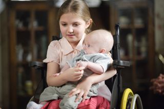 Penny Branning holding a baby