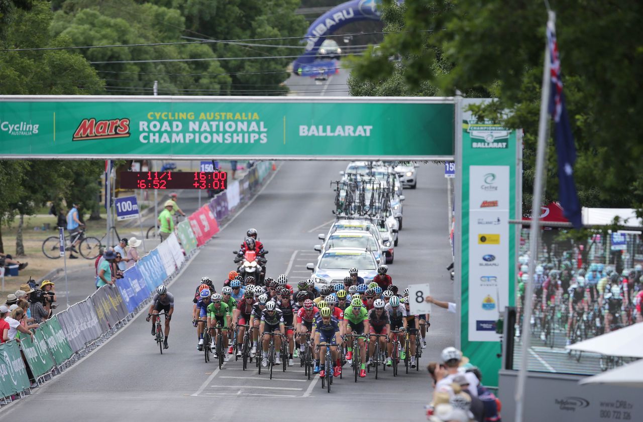 The riders pass through the finish line for another lap