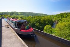 A Canal boat crossing River Dee near Llangollen on the Shropshire Union canal.