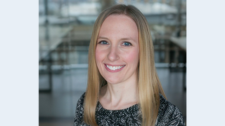 Jill Shiroma, blond haired woman in a blue print dress