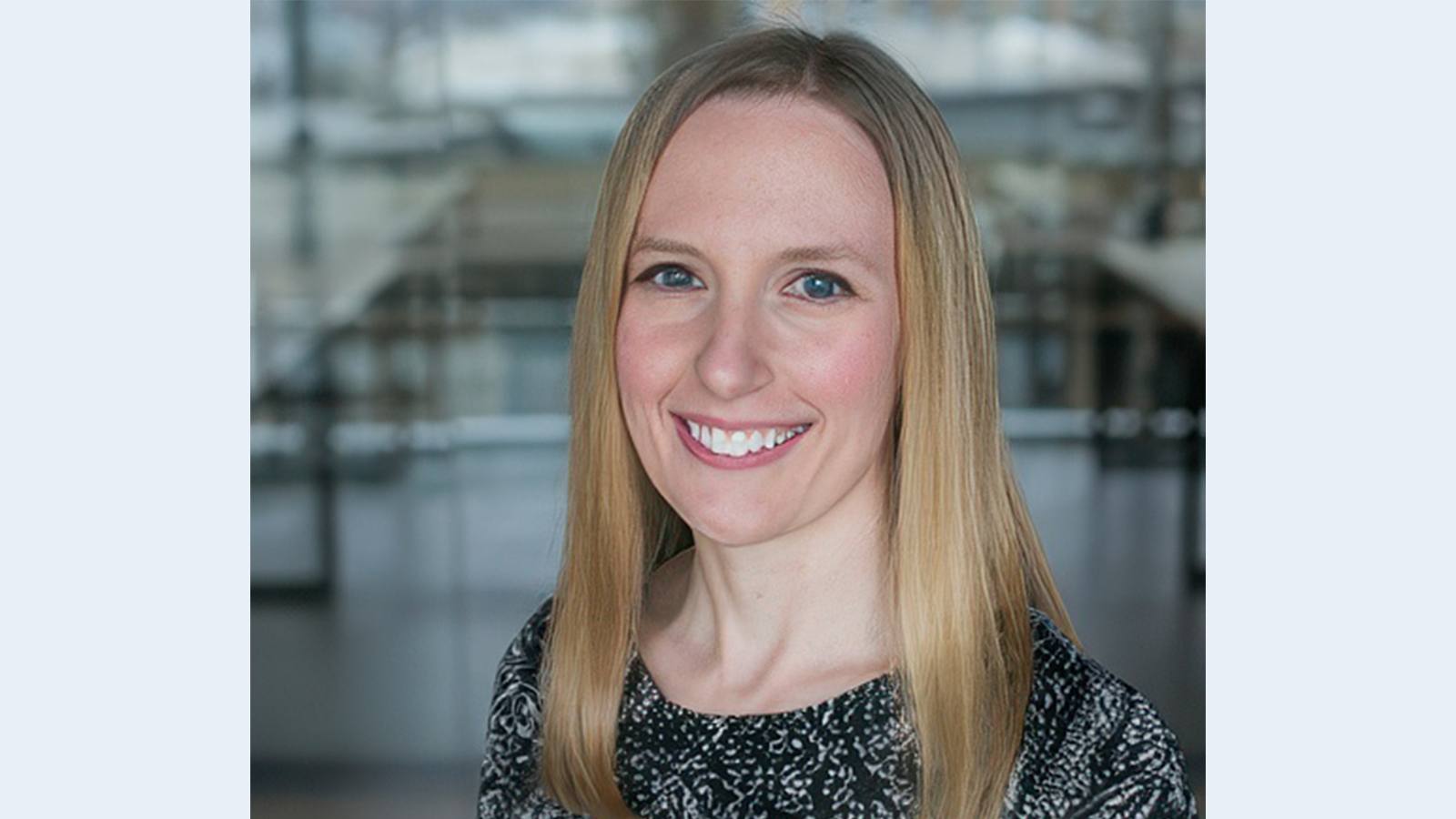 Jill Shiroma, blond haired woman in a blue print dress