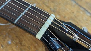 Close up bone nut on the Ferndale P3-E Parlor guitar