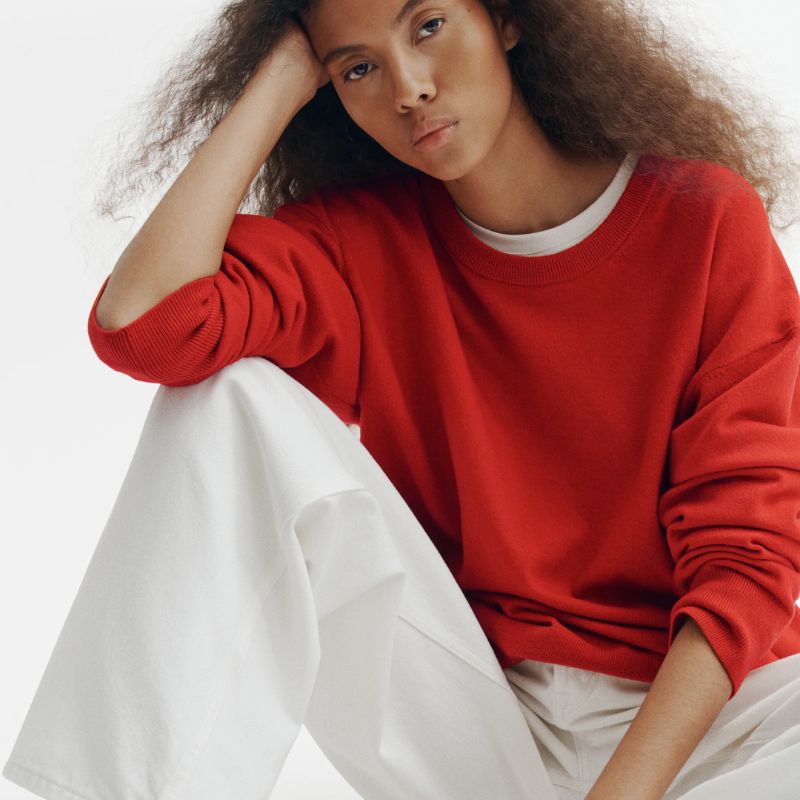 red sweater and white jeans