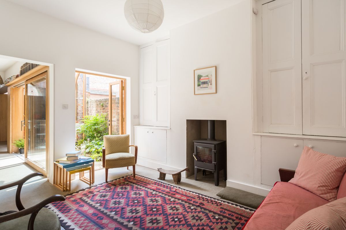 renovated living room with fireplace and view to courtyard