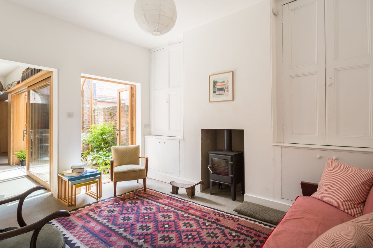 renovated living room with fireplace and view to courtyard