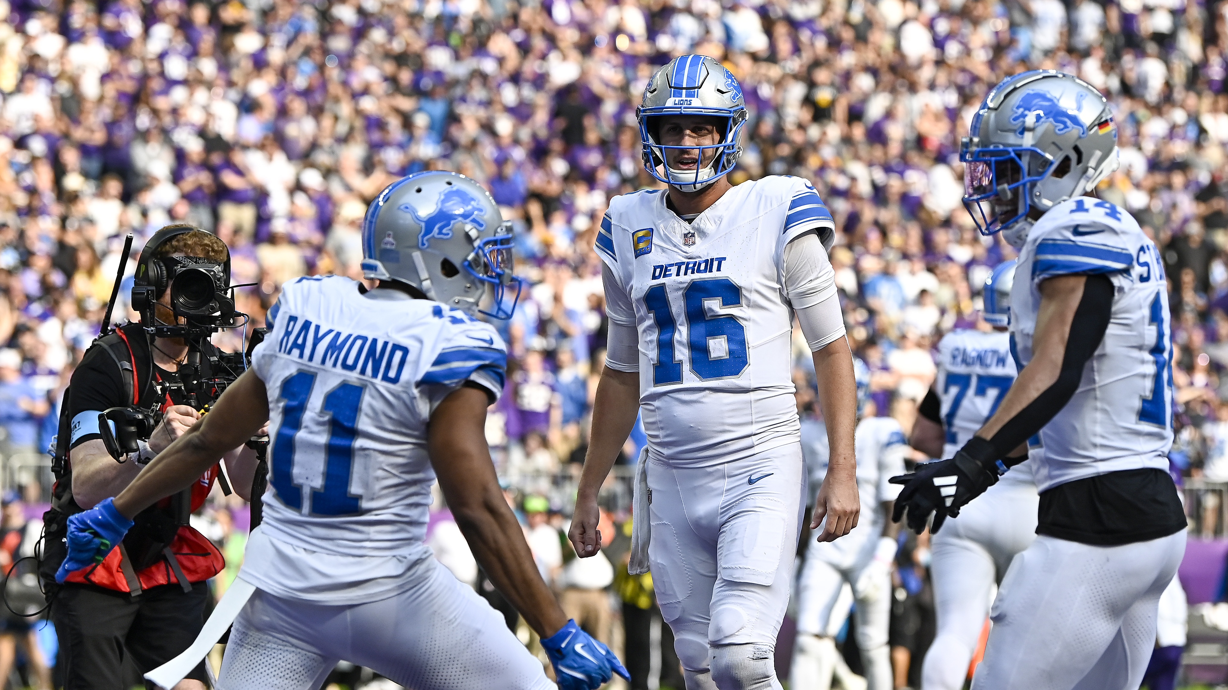 Kalif Raymond #11 of the Detroit Lions celebrates with Jared Goff #16 and Amon-Ra St. Brown #14 after scoring a touchdown in the third quarter of a game against the Minnesota Vikings at U.S. Bank Stadium on October 20, 2024 in Minneapolis, Minnesota.