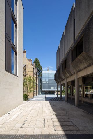 visitors go through a courtyard and between existing buildings
