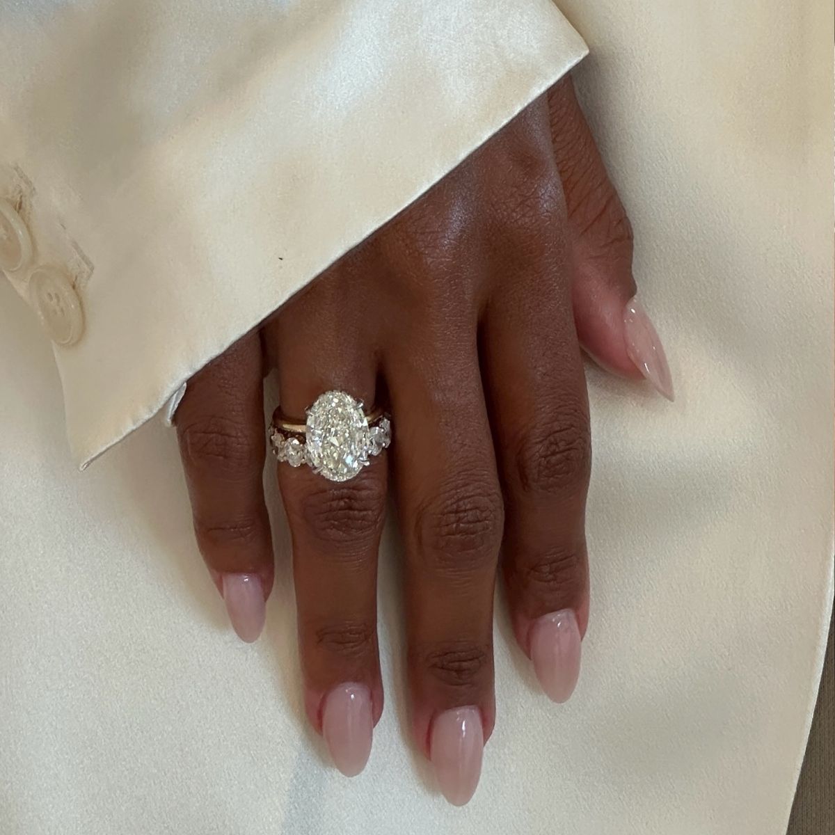 An image of @jastookes with an oval cut engagement ring. 