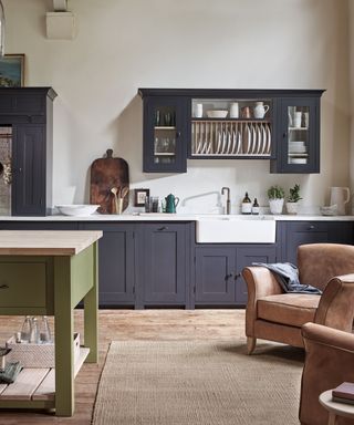 dark blue kitchen with a rug and island