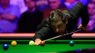 Snooker legend Ronnie O'Sullivan gets down on a shot ahead of the World China Open 2024