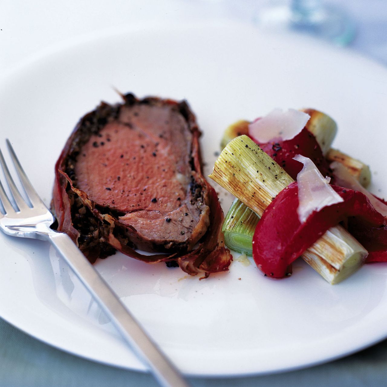 Serrano-wrapped beef fillet with mixed mushrooms accompanied by Roasted leeks and red peppers with Parmesan-recipies-woman and home